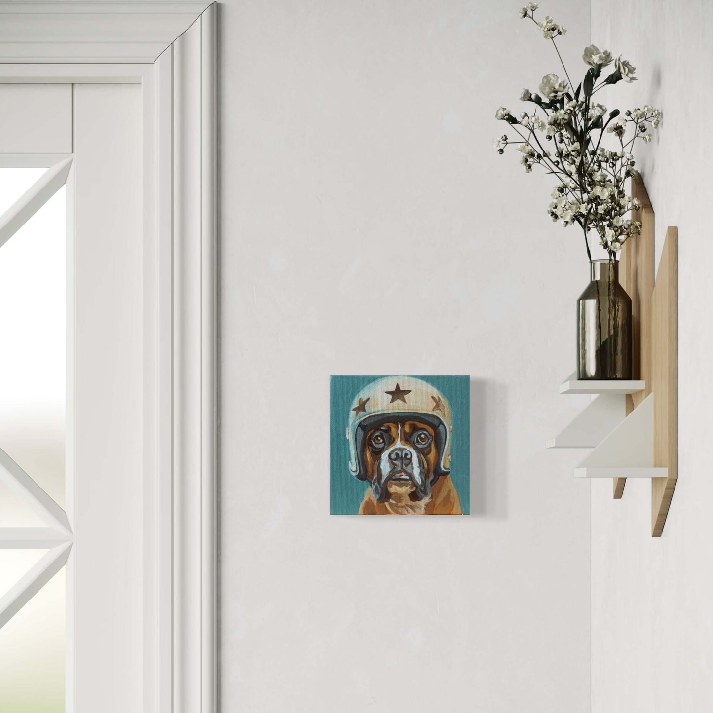 Cute dog in a helmet art print displayed on a light wall next to a floral arrangement. Perfect for pet lovers!